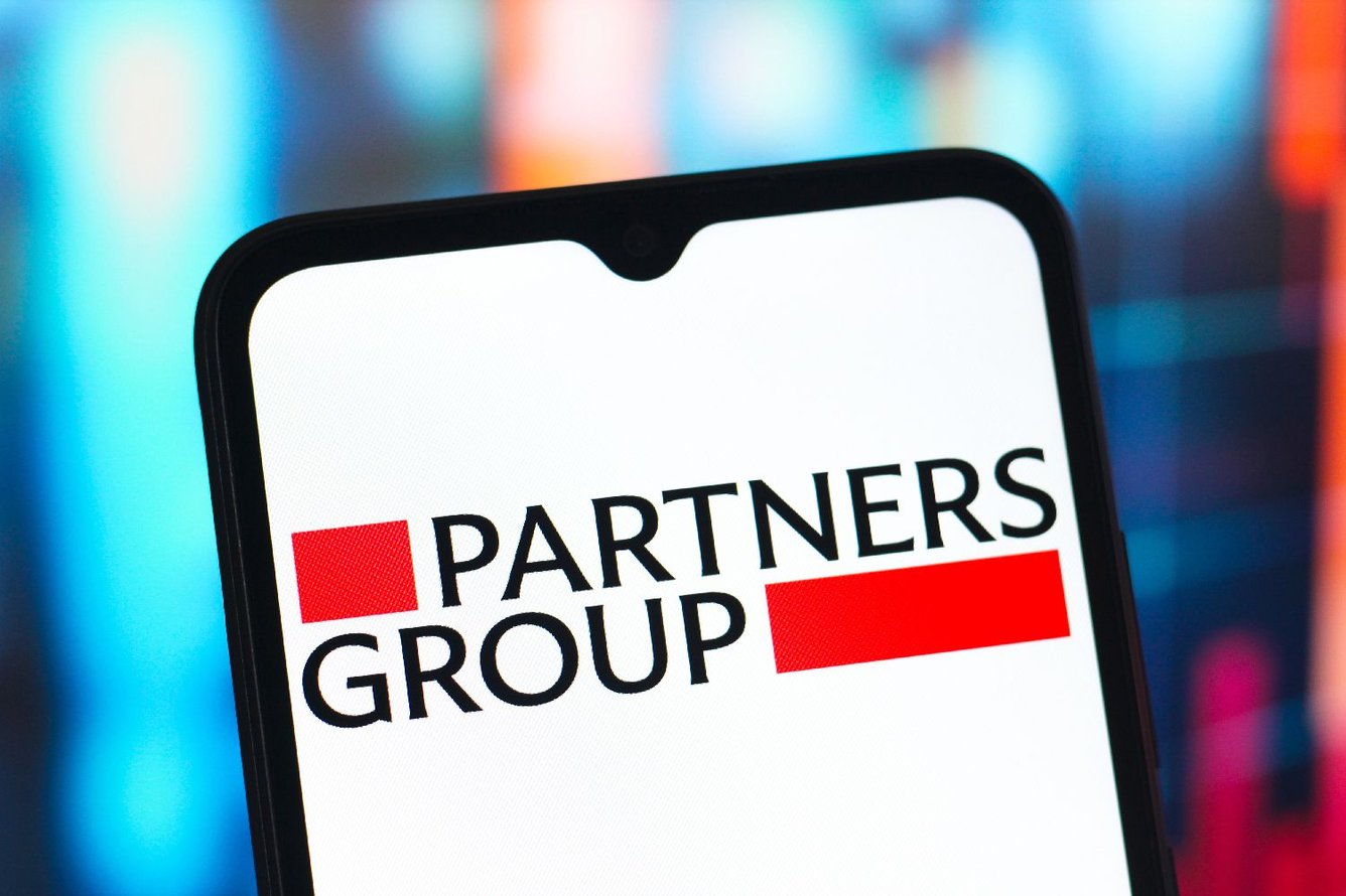 Photo illustration showing the Partners Group Holding AG logo is displayed on a smartphone screen