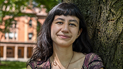 Rutgers-New Brunswick student Jane Teran leans against a tree at Voorhees Mall on the College Avenue campus.