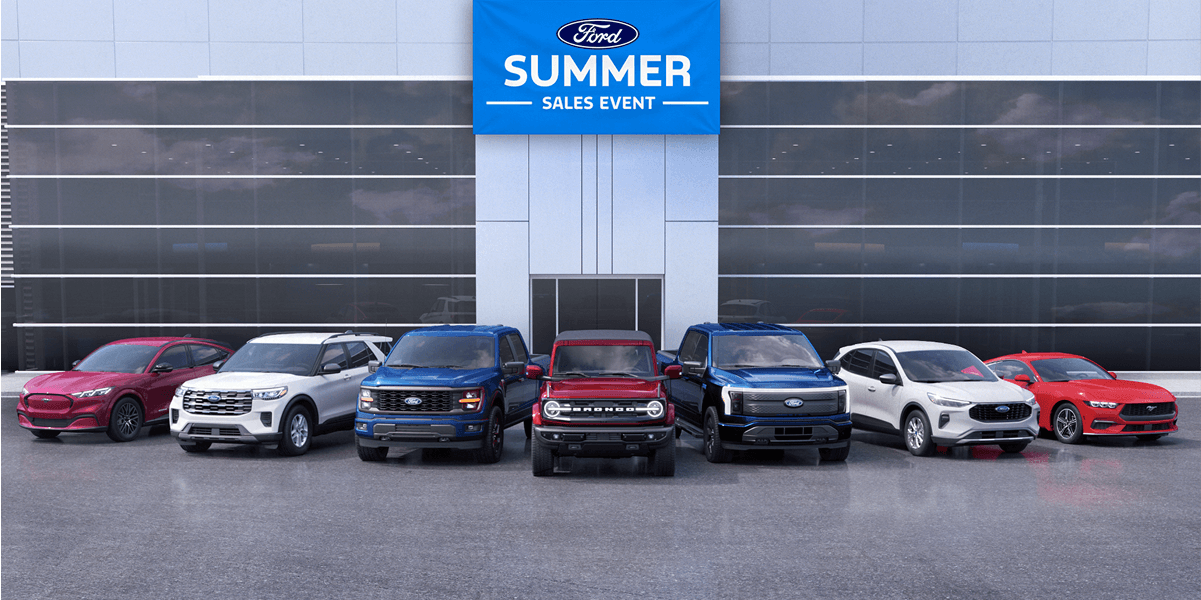 Lineup of seven Ford vehicles in front of a Ford dealership