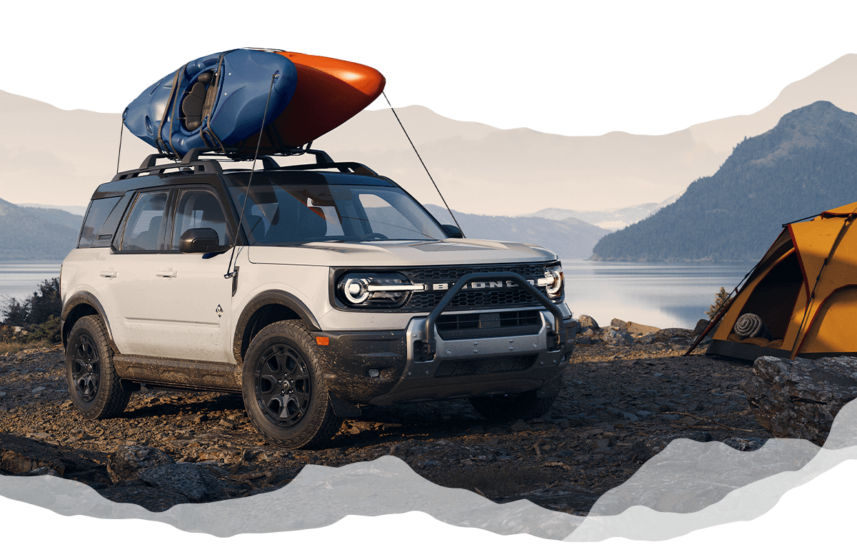 A white Ford Bronco Sport&reg; SUV with two kayaks attached to its roof