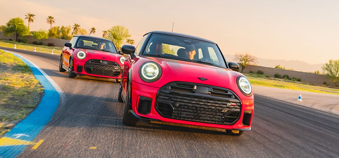 Two red MINIs on the Performance Driving School racetrack