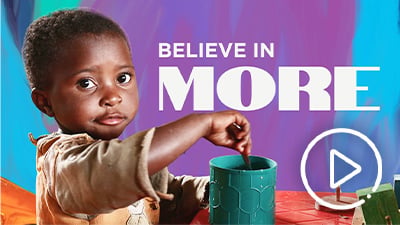 Kid stirring a mug. Believe in more