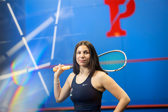 Jana Dweek holding a squash racquet.