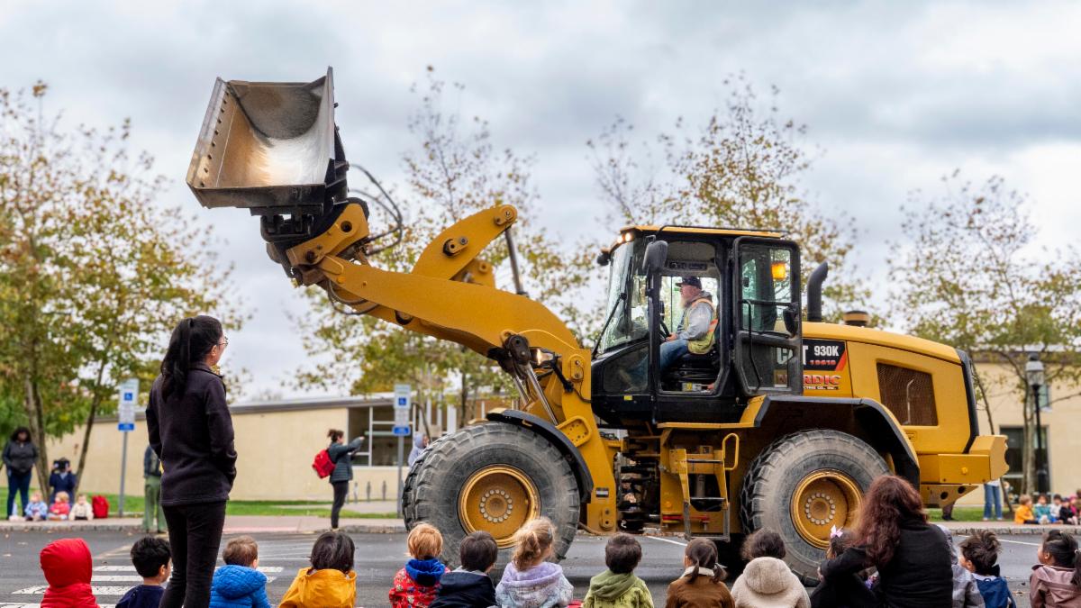 small wheel loader arrives at construction parade