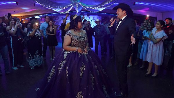 Latin Grammy winner and Democrat candidate for Texas' 15th Congressional District Bobby Pulido, sings to Melanie Nieto, 15, at her quinceanera party in Edinburg, Texas, on March 14, 2026.