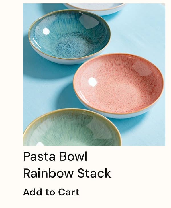 Colorful pasta bowls stacked on a light blue surface.