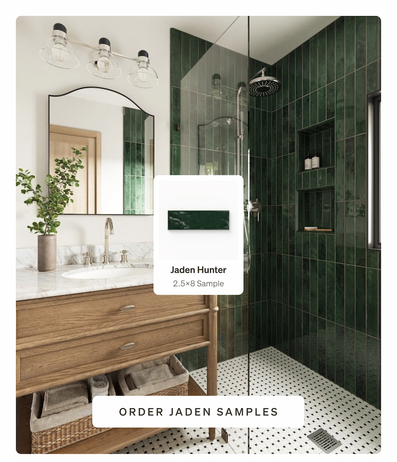 A stylish bathroom with a dark green tiled shower wall in Jaden Hunter tile, a wood vanity.
