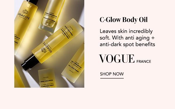 Odacité C Glow Body Oil bottles on a golden background, featuring Vogue France quote “Leaves skin incredibly soft with anti aging and anti dark spot benefits” and Shop Now.