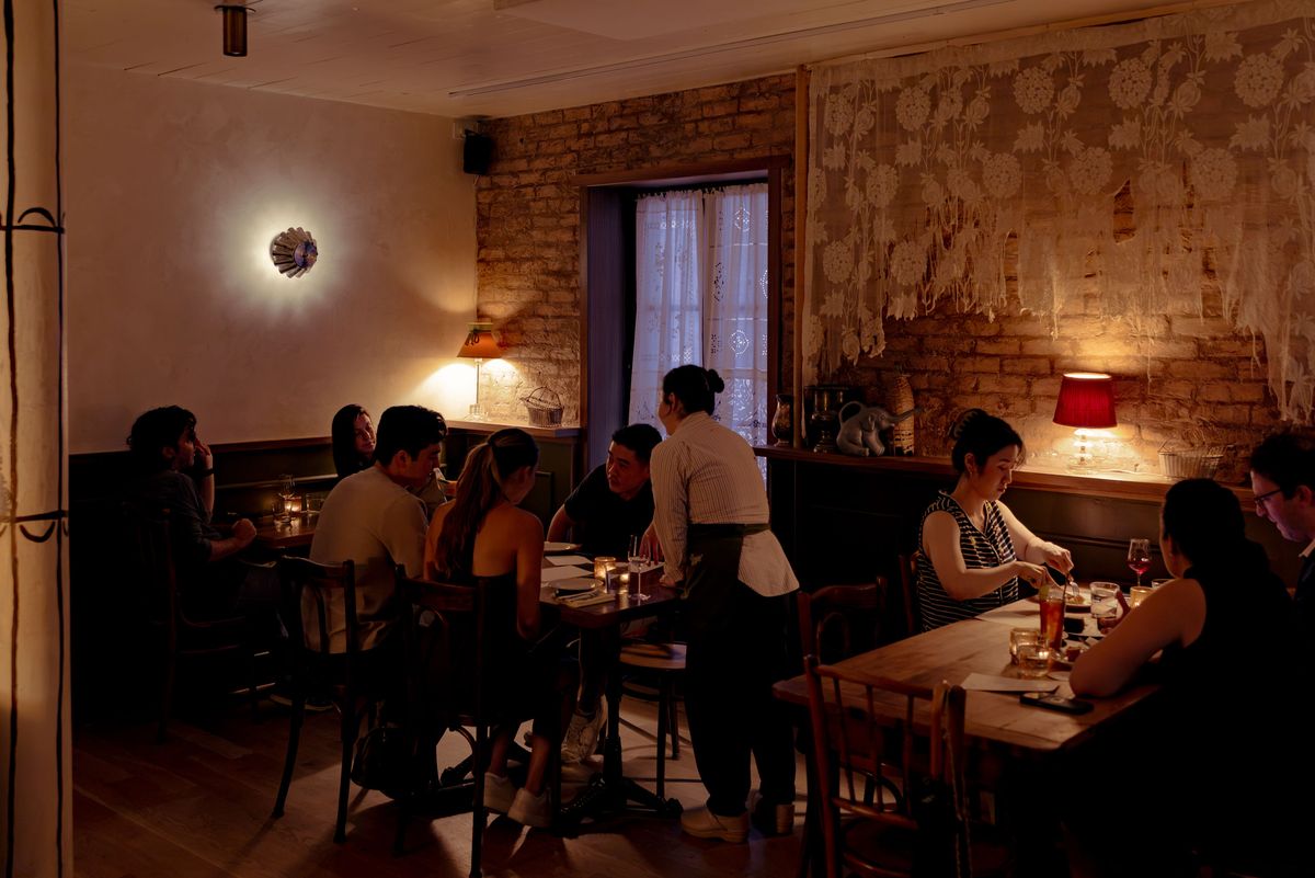 The interior of a restaurant, with guests at tables.