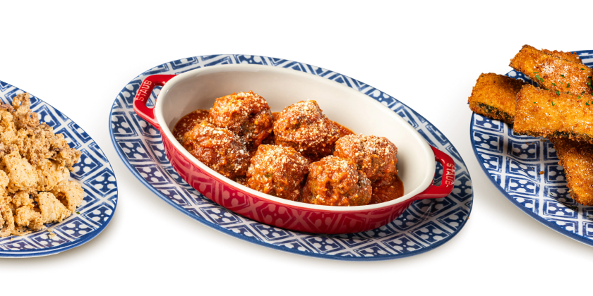 Three plates of Maggiano’s appetizers, including Calamari Fritté, Italian Meatballs, and Zucchini Fritté