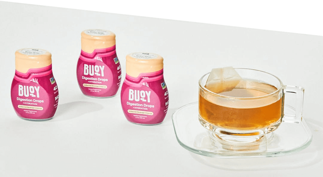 3 Digestion Drops beside tea.