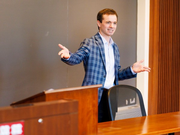 Marco Basile speaking in front of a group.