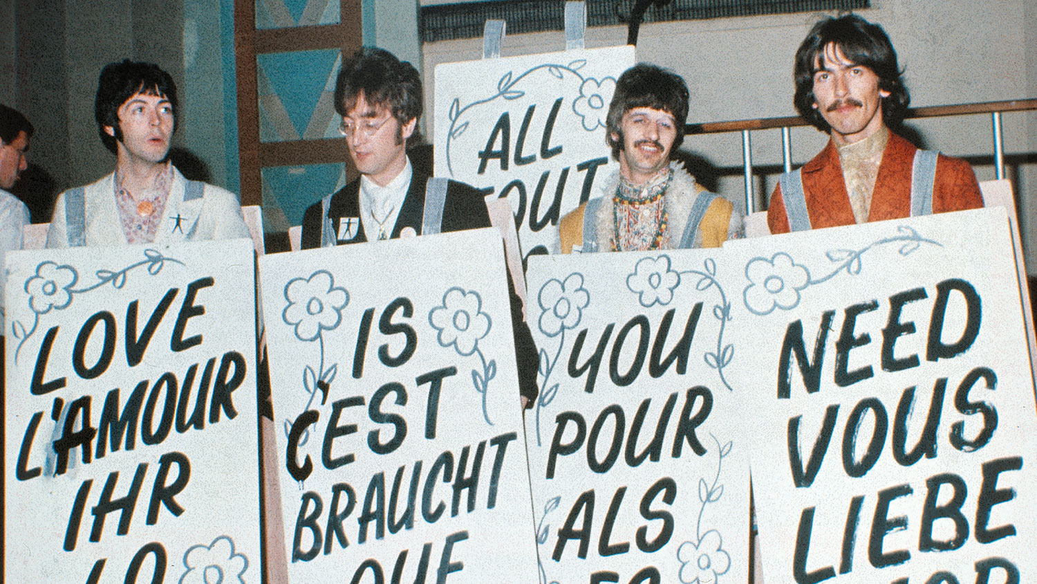 Four men hold signs.