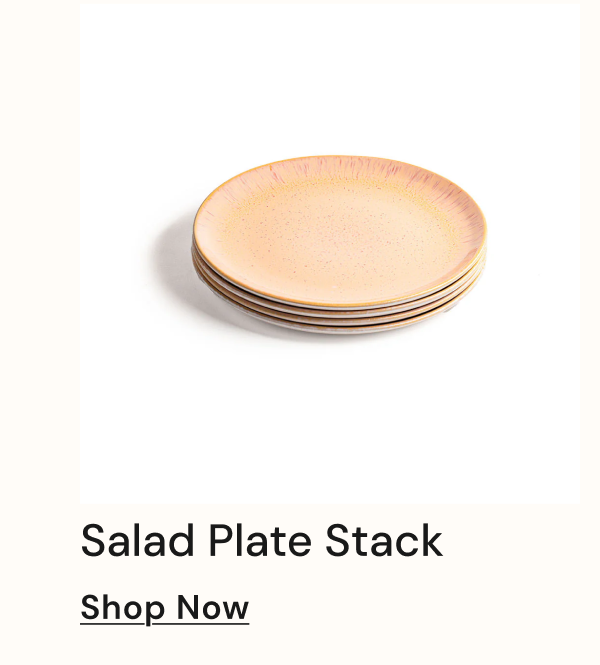 Stack of four salad plates with a pink and beige design.