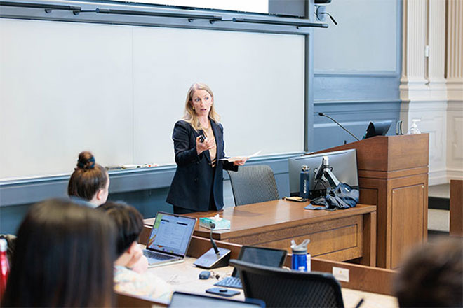 Sarah Pierce speaks in front of a classroom.