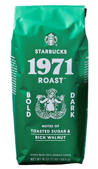 Top‐down view of a mug of Starbucks 1971 Roast™ coffee resting on a bed of coffee beans.