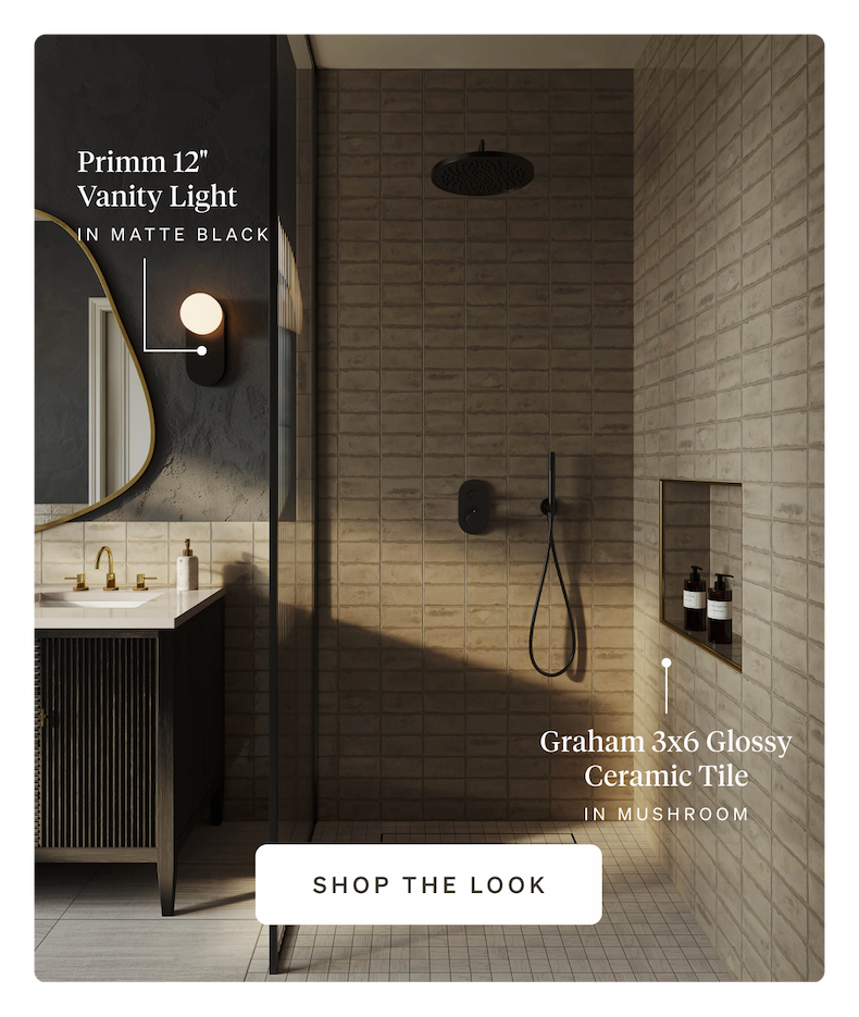 A walk-in shower featuring Mushroom glossy ceramic tile and a matte black vanity light.