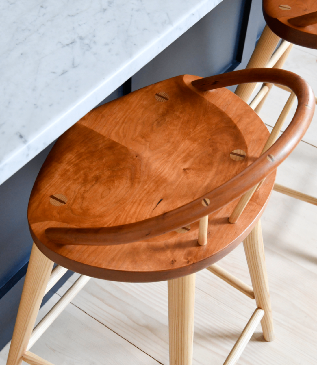 A top down view of the cherry bowback stool at a kitchen counter. 