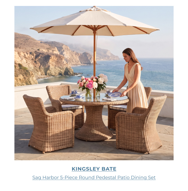 Kingsley Bate Sag Harbor 5-Piece Round Dining Set beneath a coastal patio umbrella