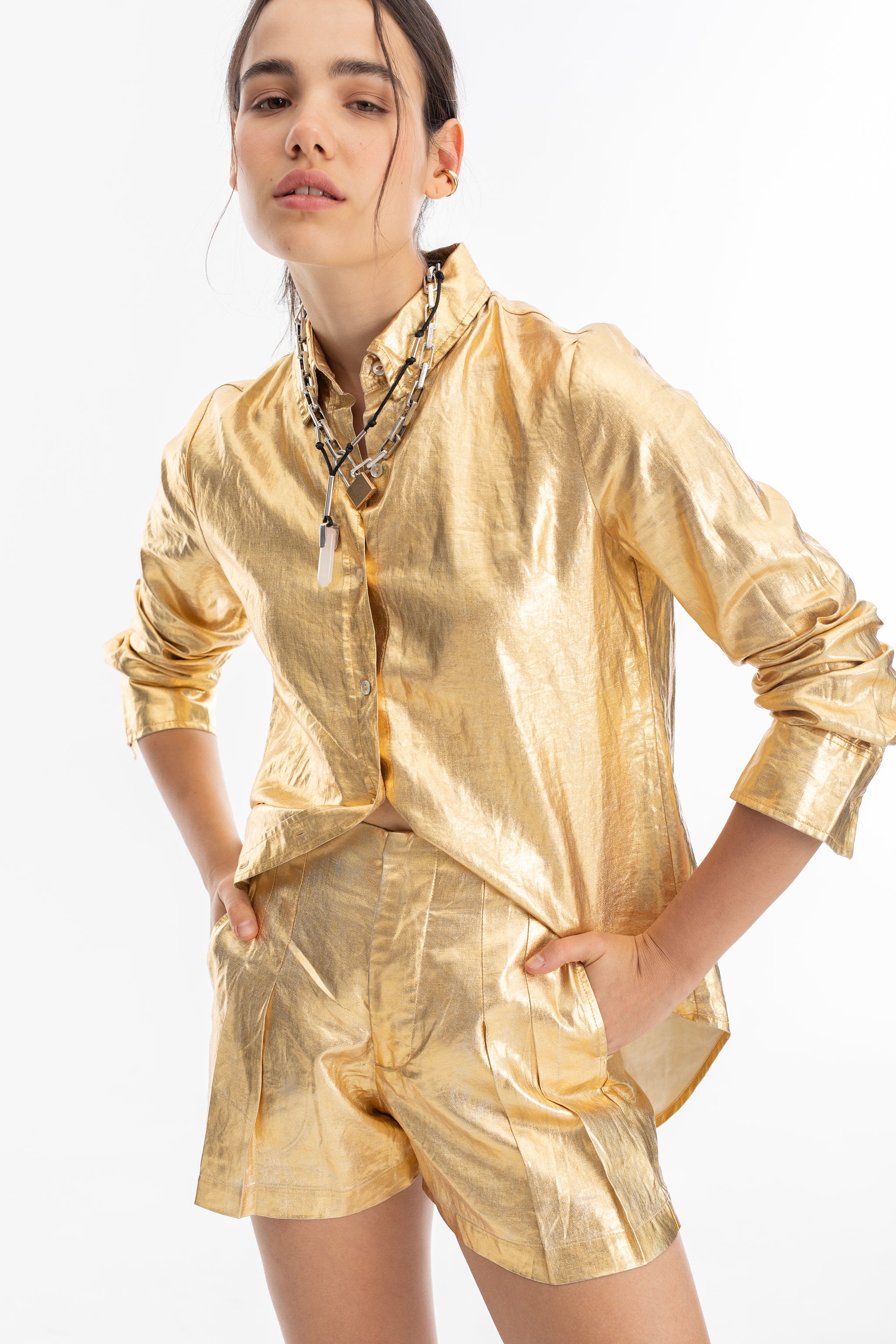 a model in a gold shirt and shorts