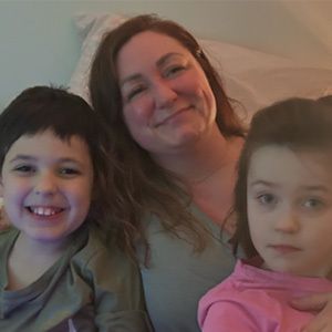 Jennifer smiles while sitting with her two children.