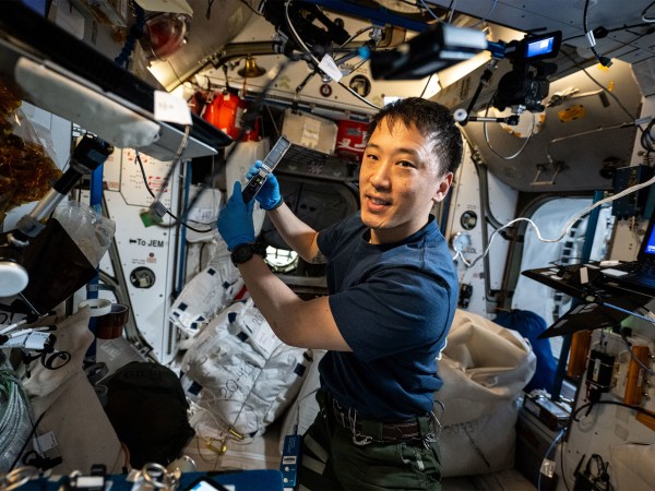 NASA astronaut and Expedition 73 Flight Engineer Jonny Kim waves for a portrait.