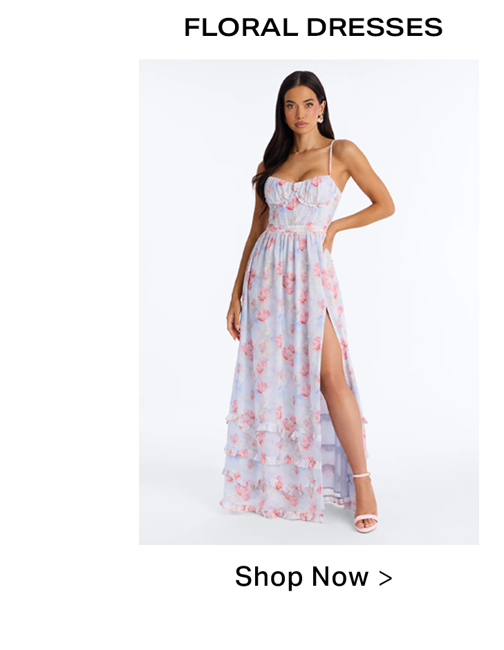 Model in a flowing light blue floral maxi dress with pink flowers, spaghetti straps, a ruched bodice, and a high slit. Shop beautiful floral dresses now.