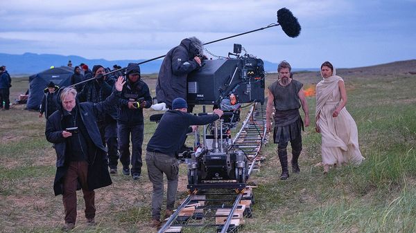 Director Christopher Nolan (frame left) with Matt Damon (as Odysseus) and Zendaya (as Athena), on set of his film THE Odessey. 