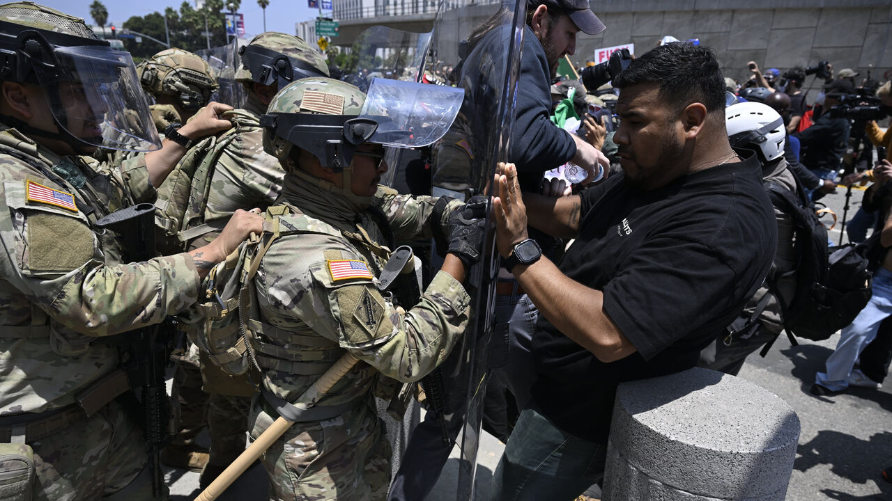 ICE officers and national guards confront with protesters outside of the Metropolitan Detention Center in Los Angeles, California, USA.