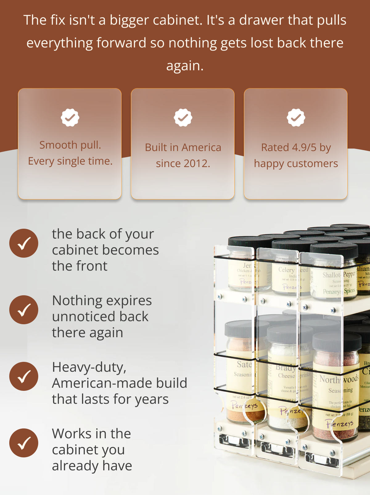 Organized spice rack drawer with multiple rows of spice jars showing how pull-out design eliminates clutter in deep kitchen cabinets