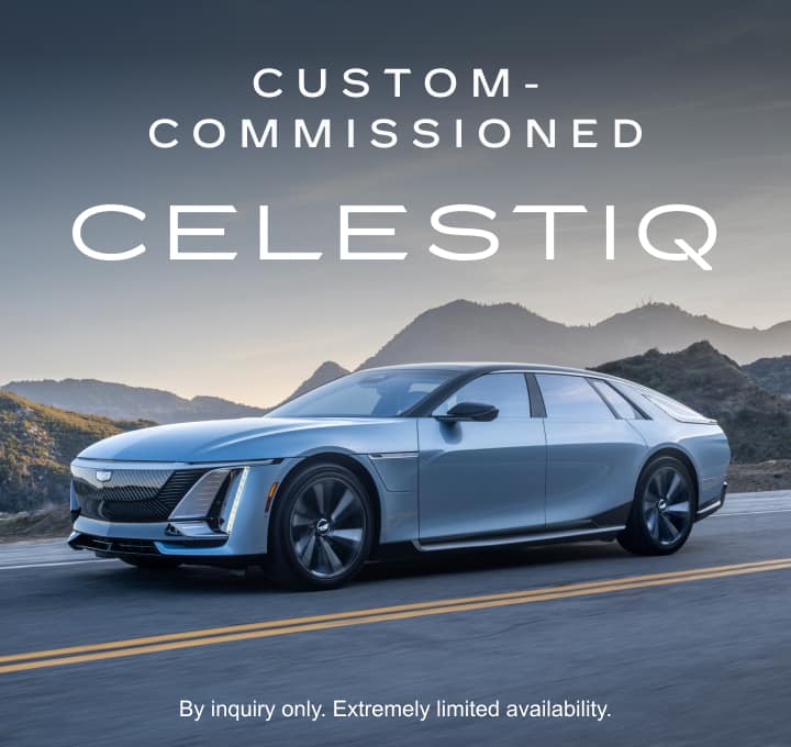 Custom-comissioned CELESTIQ. By inquiry only. Extremely limited availability. Side angle shot of a silver Cadillac CELESTIQ driving along a winding road through a mountainous landscape. 