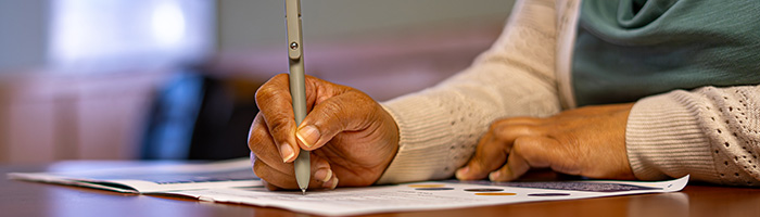 Person writing on paper.
