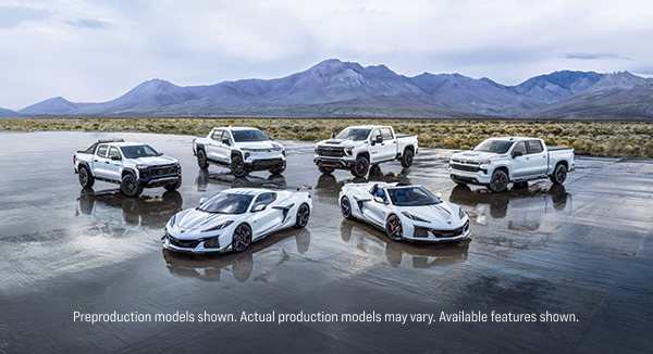 Pack shot of the Stars and Steel vehicle collection parked outside in an open lot with a mountain range in the distant background.