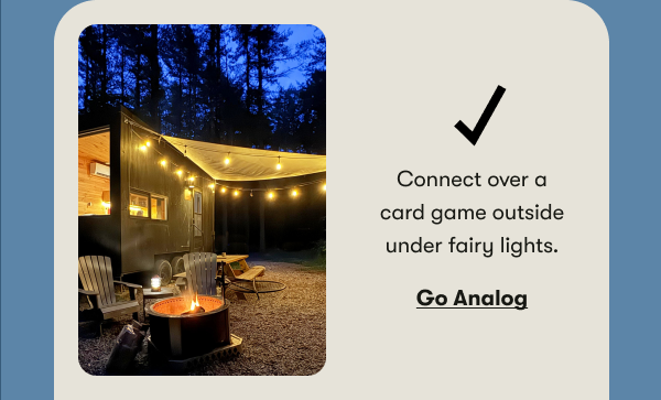 Connect over a card game outside under fairy lights.