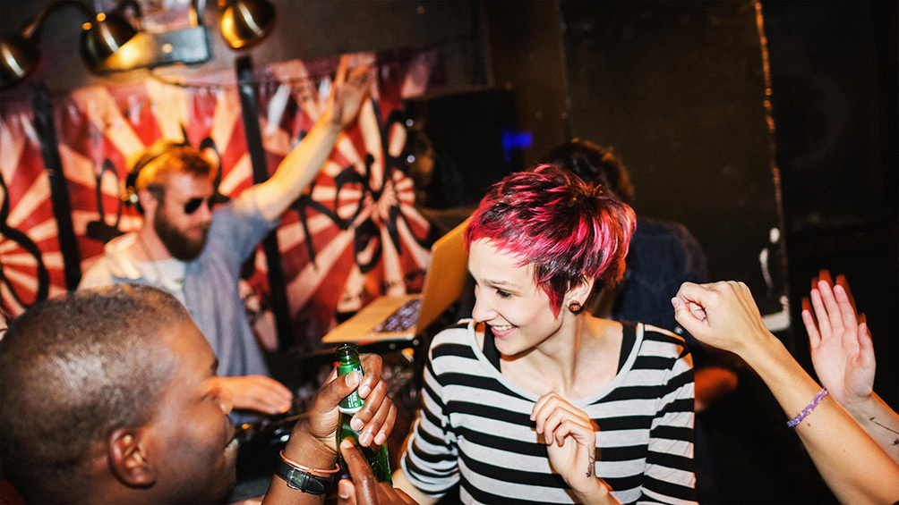 Image description: Friends dancing at a club in Berlin.
