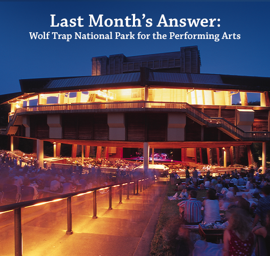 A nighttime view of the illuminated stage and walkways at Wolf Trap National Park for the Performing Arts