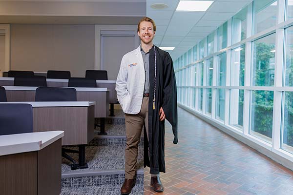 This Hoo is receiving two degrees at once. But that’s not his proudest achievement
