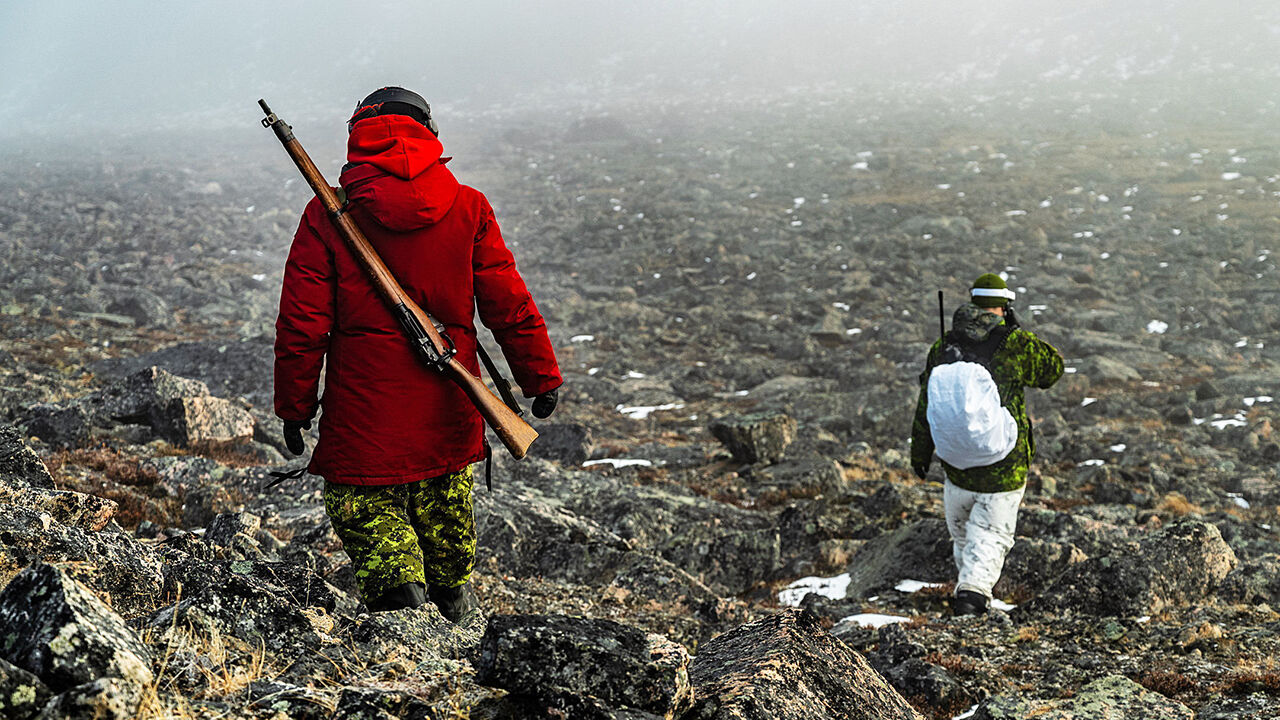 Members of Land Task Force NUNAKPUT walk to their observation post during Operation NANOOK-NUNAKPUT near Pond Inlet, Nunavut
