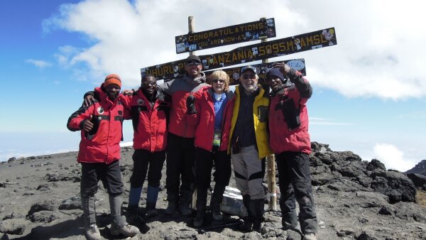 Art Ulene (second from right) and his wife, Priscilla (third from right), pose for a photo at the top of Mount Kilimanjaro in 2011 with their guides.