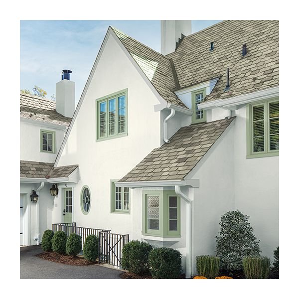 A home exterior with stucco painted off-white with a gray roof and white trim.