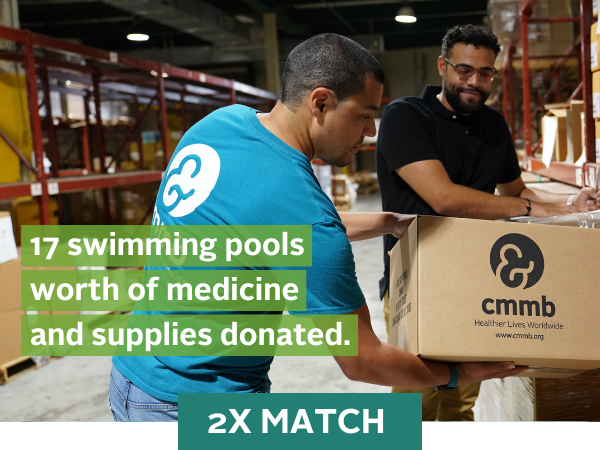 Two workers in CMMB's distribution center prepare international aid shipments