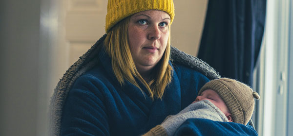 Chloe and her baby wearing hats and extra layers inside