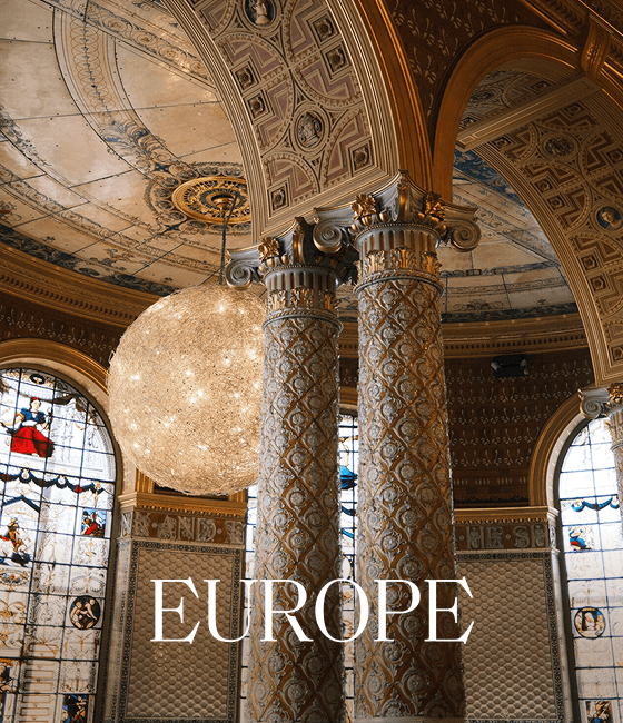 Ornate interior with domed ceiling, columns, and large chandelier, overlaid with 'EUROPE'.