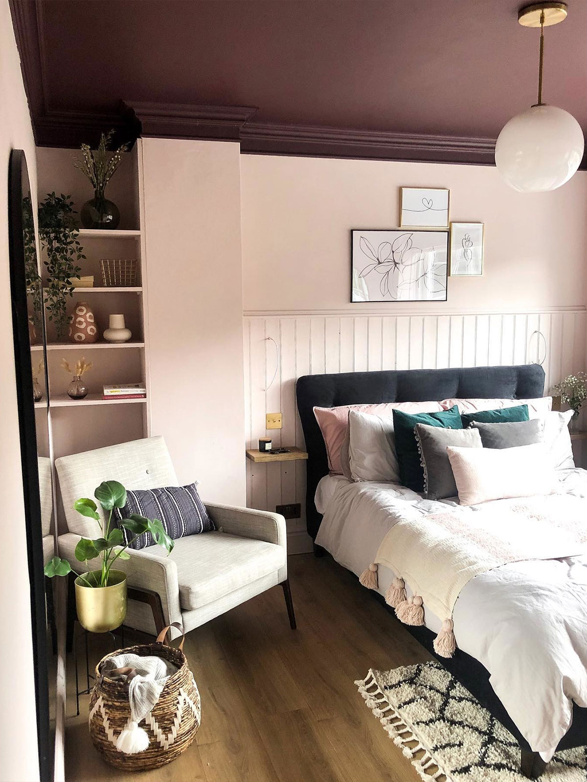If you only looked at the walls in this bedroom, you would think it’s a very traditional, pretty and romantic room. But as you lie back amongst the plump pile of cushions on the bed, you’ll spot the deep, sophisticated aubergine tone of the ceiling. Perhaps you’ll look up at it from the comfy bedside chair. With accents of dark green from plants, ink tones from the velvet bedhead, and the soft glow of the burnished gold plant pot, there’s little surprises wherever you look.