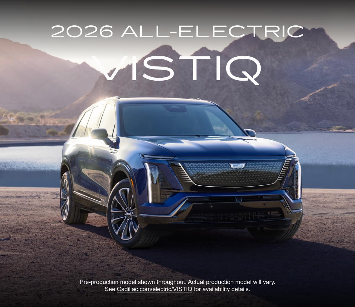 Three-quarter view of the 2026 Cadillac VISTIQ parked against a rocky background with mountains and a lake.
