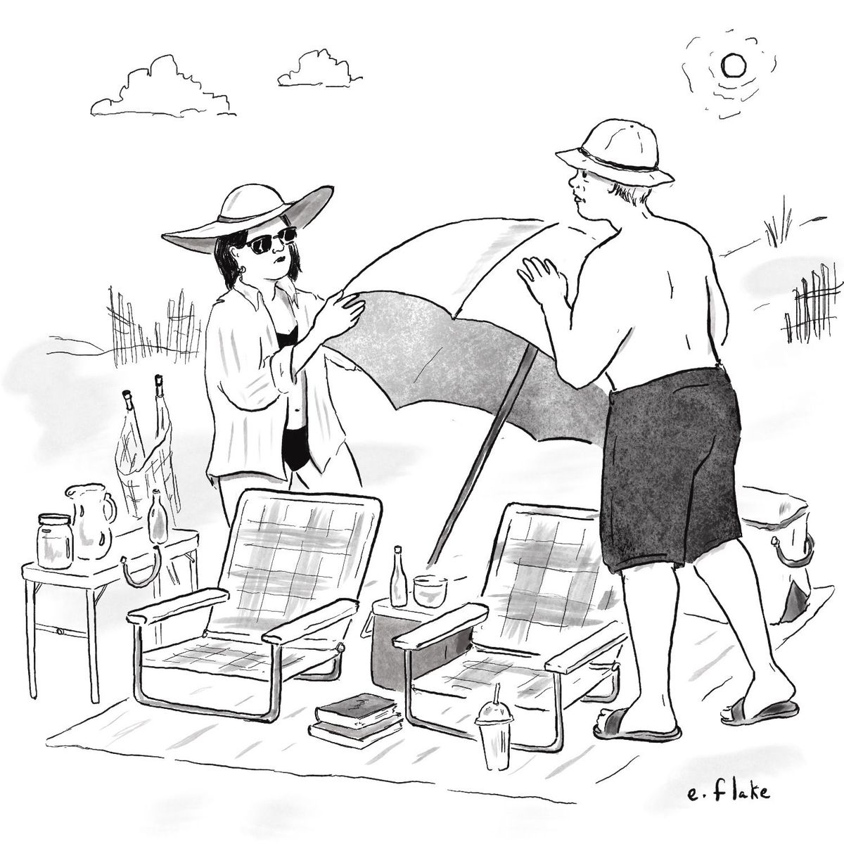 Two people setting up at the beach.