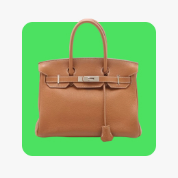 A tan-colored Hermès Birkin bag sits on a lime green tile.