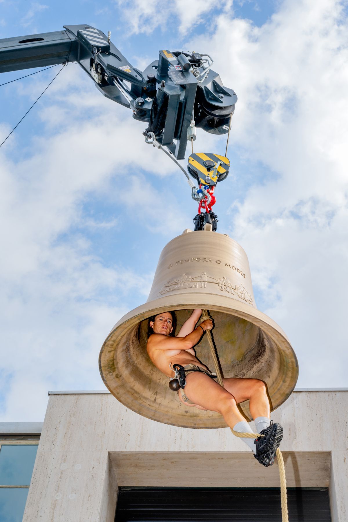 A person inside of a bell.