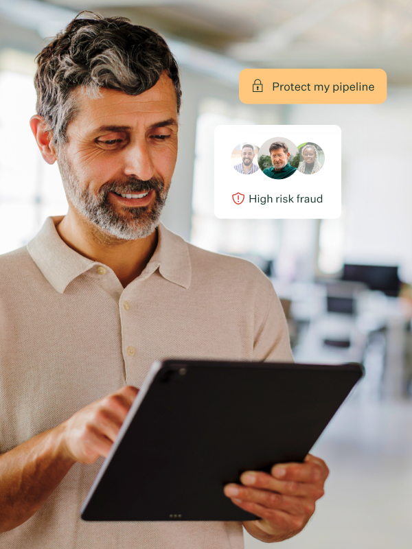 Image-of-a-male-on-tablet-in-office-space-with-protect-my-pipeline-pill-and-high-risk-fraud-UI