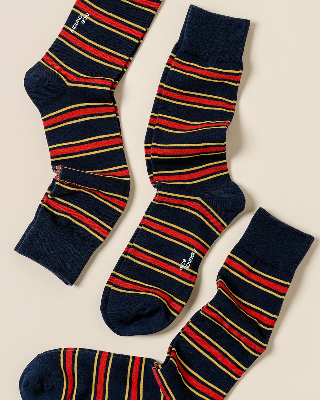 pair of navy dress socks with yellow/red stripes